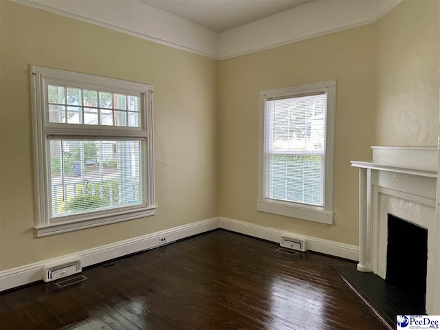 101 W Baptist St, Marion, SC 29571 - unfurnished living room with healthy amount of natural light, dark wood-type flooring, and a premium fireplace