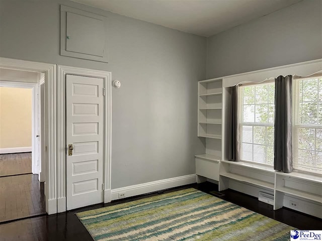 101 W Baptist St, Marion, SC 29571 - interior space with baseboards and dark wood-style floors