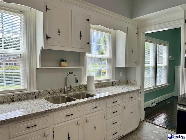 101 W Baptist St, Marion, SC 29571 - kitchen featuring open shelves, white cabinets, light wood-style flooring, and light stone counters