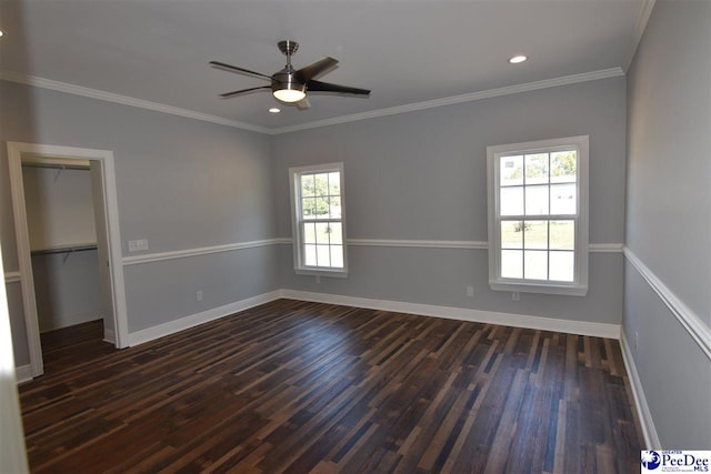 unfurnished bedroom featuring dark hardwood / wood-style flooring, crown molding, a closet, and ceiling fan