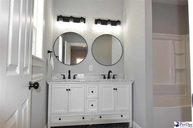 bathroom with vanity and a shower