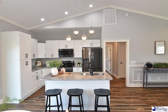 kitchen with white cabinetry, sink, stainless steel fridge, electric range, and a center island with sink