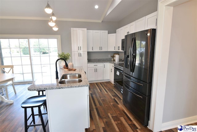 kitchen featuring sink, white cabinetry, black appliances, an island with sink, and light stone countertops