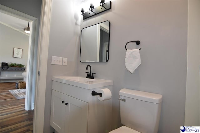 bathroom with vanity, hardwood / wood-style flooring, and toilet