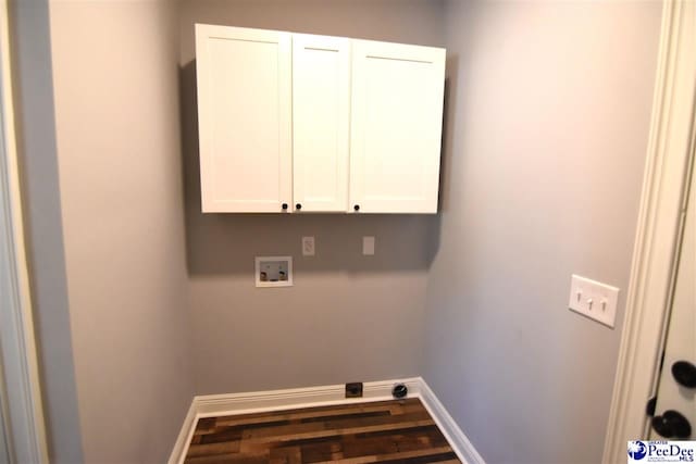 laundry area with washer hookup, wood-type flooring, and cabinets