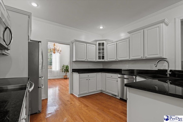 1642 Jefferson Dr, Florence, SC 29501 - kitchen featuring stainless steel appliances, a sink, ornamental molding, light wood-style flooring, and a chandelier