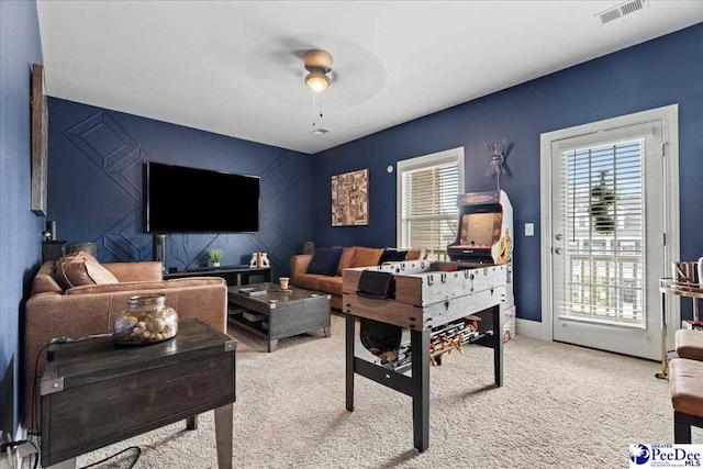 207 Compass Trl, Blythewood, SC 29016 - carpeted living area with an accent wall, a ceiling fan, visible vents, and a wealth of natural light