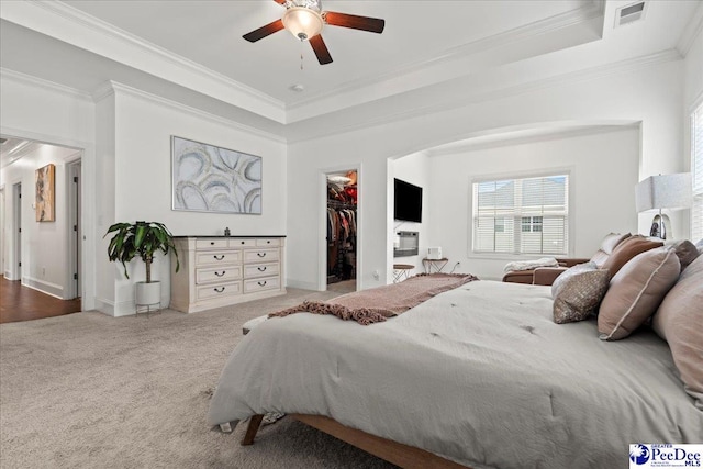 207 Compass Trl, Blythewood, SC 29016 - carpeted bedroom with a closet, crown molding, a walk in closet, visible vents, and a tray ceiling