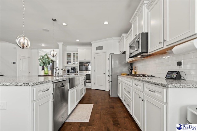 207 Compass Trl, Blythewood, SC 29016 - kitchen with white cabinetry, decorative backsplash, appliances with stainless steel finishes, and a center island with sink