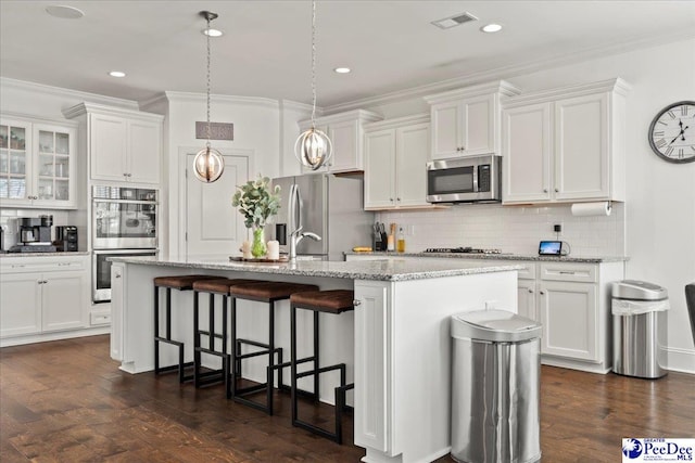 207 Compass Trl, Blythewood, SC 29016 - kitchen with white cabinets, visible vents, ornamental molding, and appliances with stainless steel finishes
