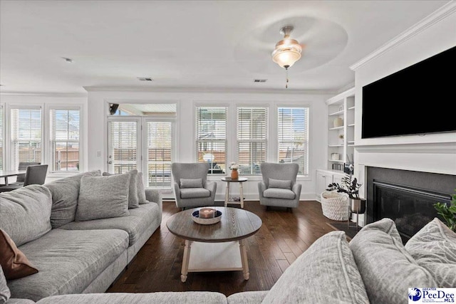 207 Compass Trl, Blythewood, SC 29016 - living room featuring crown molding, built in features, ceiling fan, a glass covered fireplace, and hardwood / wood-style flooring