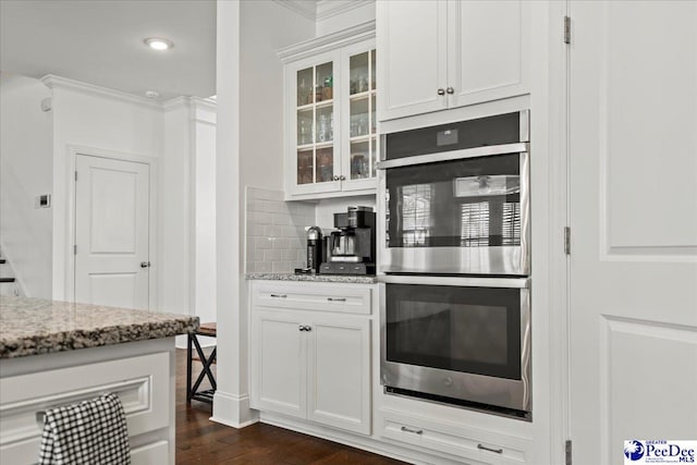 207 Compass Trl, Blythewood, SC 29016 - kitchen with glass insert cabinets, stainless steel double oven, white cabinetry, decorative backsplash, and dark wood-style floors