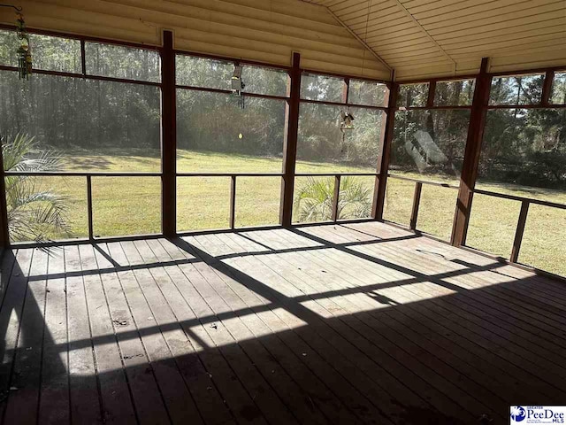 unfurnished sunroom featuring lofted ceiling