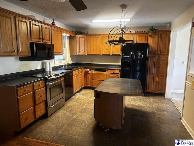 kitchen with decorative light fixtures, brown cabinetry, a kitchen island, a sink, and black appliances