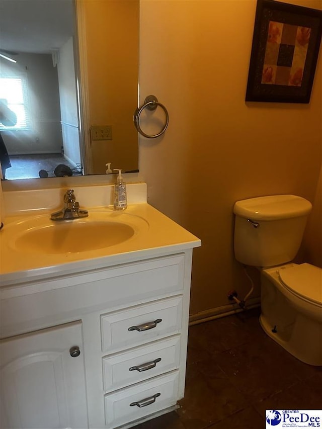 half bath featuring toilet and vanity