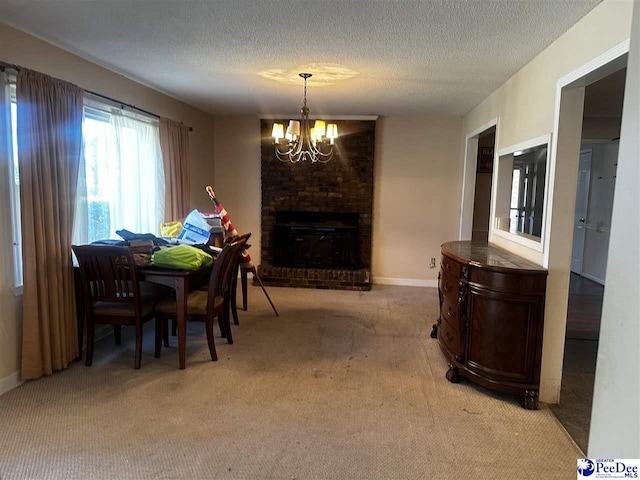 dining room featuring a chandelier, carpet floors, a textured ceiling, and a fireplace