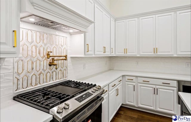 kitchen with decorative backsplash, dark hardwood / wood-style floors, white cabinets, and premium range hood