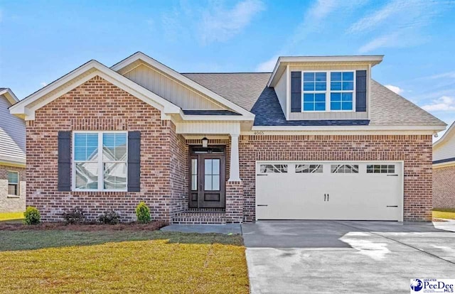 view of front of home featuring a garage and a front yard