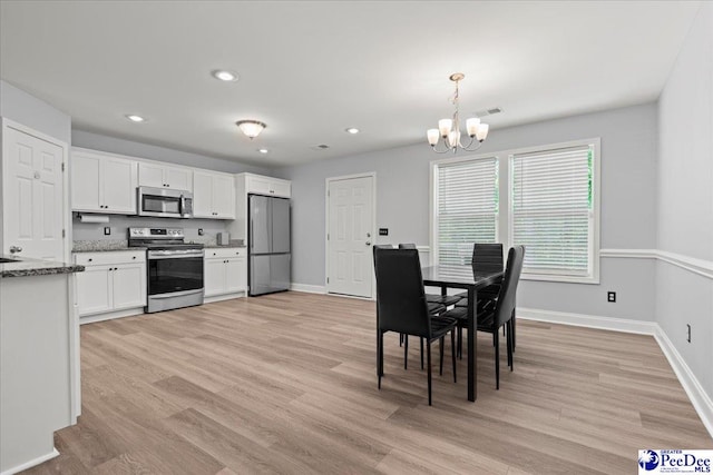 3324 Spiral Ln, Effingham, SC 29541 - dining area featuring a chandelier, baseboards, and light wood finished floors