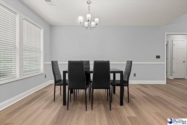 3324 Spiral Ln, Effingham, SC 29541 - dining room featuring baseboards, a notable chandelier, and light wood finished floors