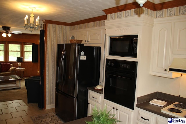 kitchen featuring hanging light fixtures, ceiling fan with notable chandelier, black appliances, and white cabinets