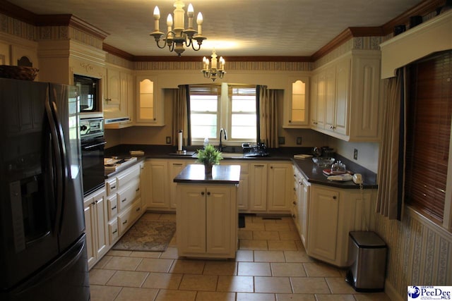 kitchen with pendant lighting, a center island, a notable chandelier, black appliances, and crown molding