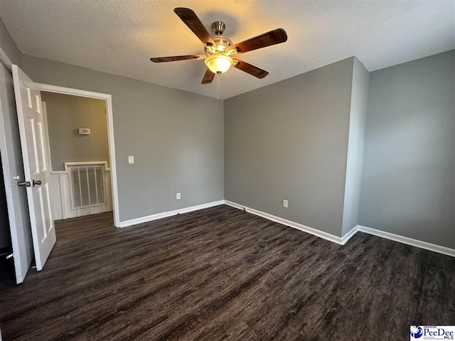 unfurnished bedroom with dark wood-type flooring, ceiling fan, and a textured ceiling