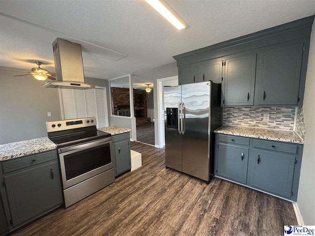 kitchen featuring ceiling fan, appliances with stainless steel finishes, dark hardwood / wood-style floors, island exhaust hood, and decorative backsplash