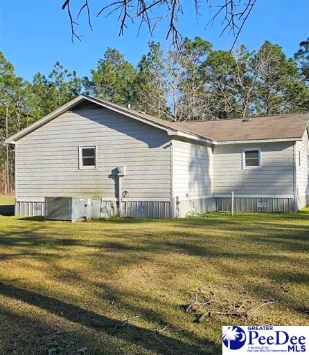 view of side of home with a lawn