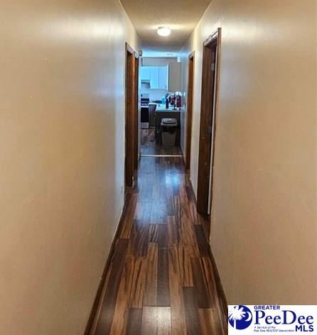 corridor featuring dark hardwood / wood-style floors