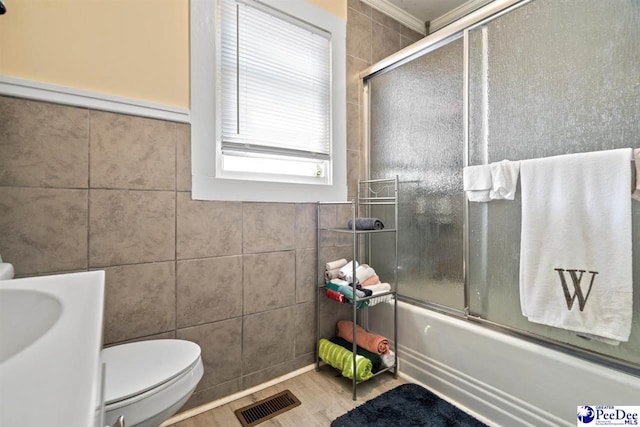 427 Marlboro Ave, Hartsville, SC 29550 - bathroom featuring enclosed tub / shower combo, toilet, hardwood / wood-style floors, and tile walls