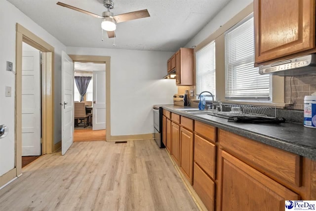 427 Marlboro Ave, Hartsville, SC 29550 - kitchen featuring sink, ceiling fan, backsplash, electric range, and light hardwood / wood-style floors