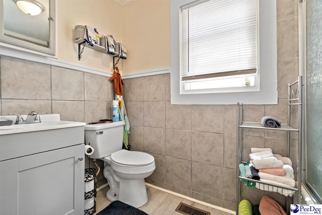 427 Marlboro Ave, Hartsville, SC 29550 - bathroom with vanity, toilet, wood-type flooring, and tile walls
