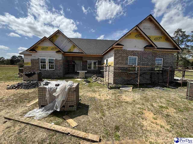 rear view of house featuring brick siding