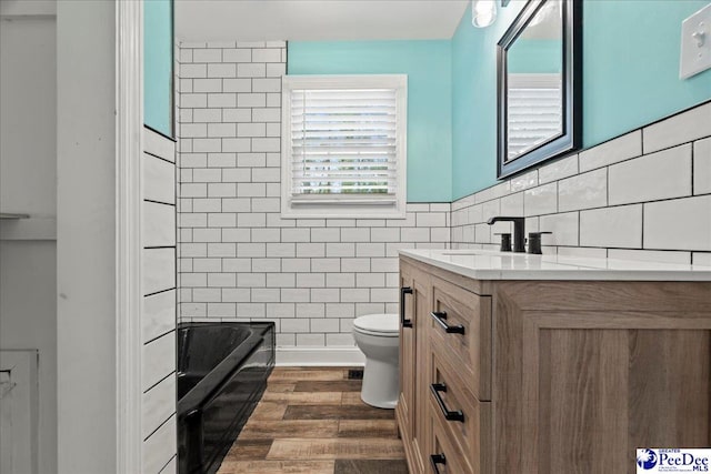 821 W Shirley Rd, Pamplico, SC 29583 - full bathroom featuring vanity, toilet, tile walls, and wood finished floors