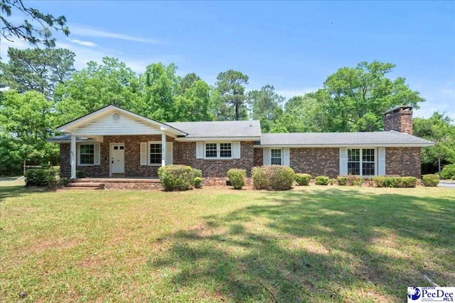 821 W Shirley Rd, Pamplico, SC 29583 - ranch-style home with brick siding, a front yard, a chimney, and a porch