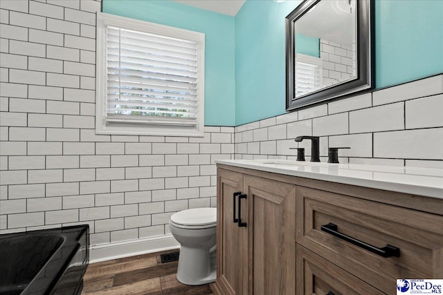821 W Shirley Rd, Pamplico, SC 29583 - bathroom with vanity, toilet, tile walls, and wood finished floors