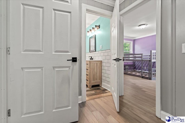 821 W Shirley Rd, Pamplico, SC 29583 - hallway featuring wood finished floors and ornamental molding