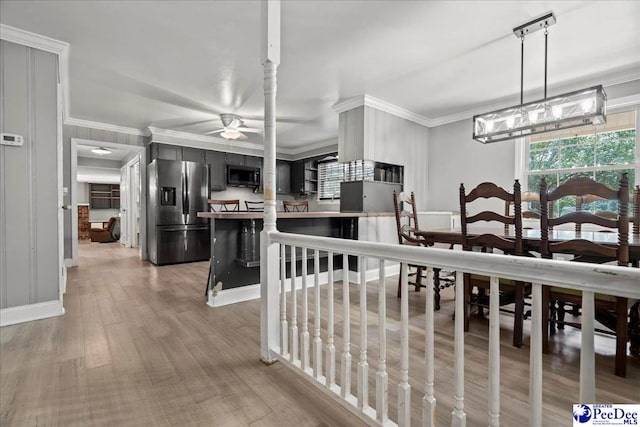 821 W Shirley Rd, Pamplico, SC 29583 - kitchen with stainless steel refrigerator with ice dispenser, crown molding, ceiling fan, light wood-type flooring, and baseboards