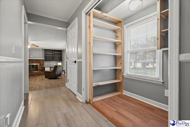 821 W Shirley Rd, Pamplico, SC 29583 - corridor featuring wood finished floors, baseboards, and a textured ceiling