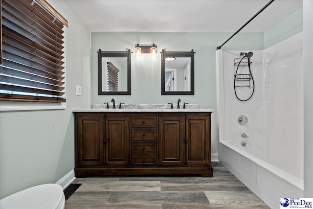 821 W Shirley Rd, Pamplico, SC 29583 - full bathroom featuring  shower combination, wood finished floors, double vanity, toilet, and baseboards