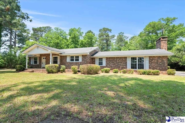 821 W Shirley Rd, Pamplico, SC 29583 - ranch-style house with a front lawn, brick siding, a chimney, and a porch