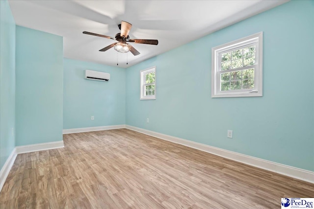 821 W Shirley Rd, Pamplico, SC 29583 - unfurnished room featuring a wall mounted AC, a ceiling fan, baseboards, and light wood-style floors