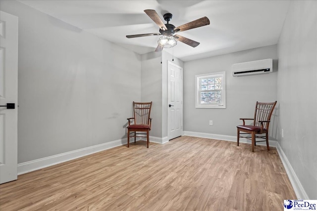821 W Shirley Rd, Pamplico, SC 29583 - sitting room featuring a wall unit AC, light wood finished floors, a ceiling fan, and baseboards