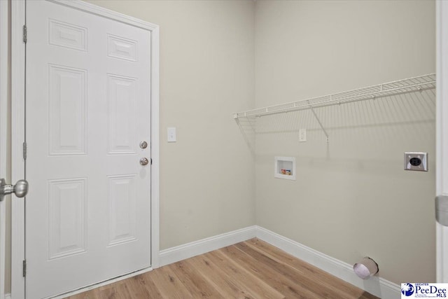 clothes washing area featuring electric dryer hookup, hookup for a washing machine, and wood-type flooring