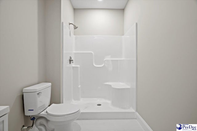 bathroom featuring a shower and toilet