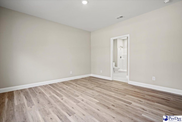 empty room with light hardwood / wood-style flooring