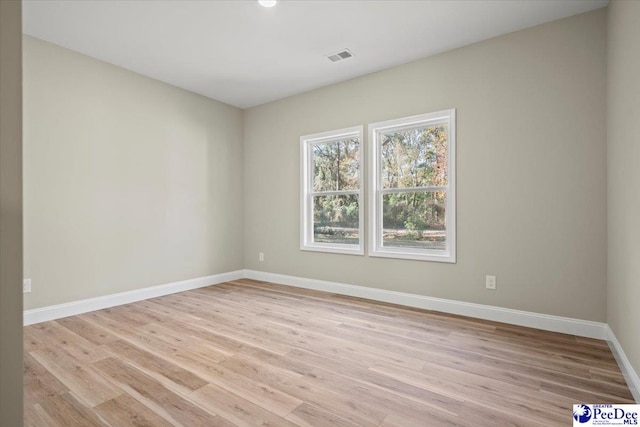 spare room featuring light hardwood / wood-style floors