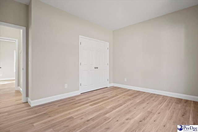 unfurnished room with light wood-type flooring