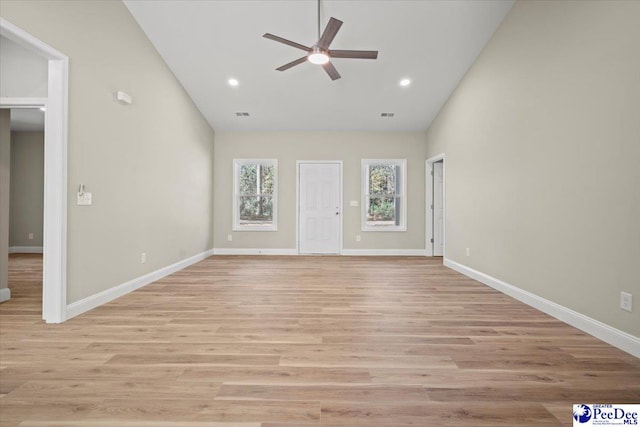 unfurnished living room with light hardwood / wood-style flooring, high vaulted ceiling, and ceiling fan